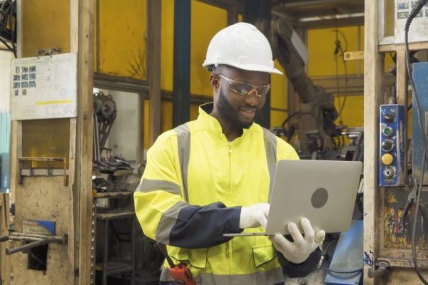 Black African American man, an engineer or worker use laptop not